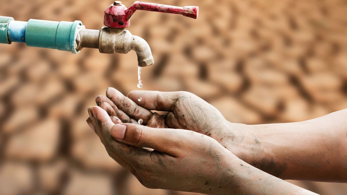 A dry tap over cracked earth illustrates the severe water scarcity following Maharashtra's drought declaration across 265 tehsils.