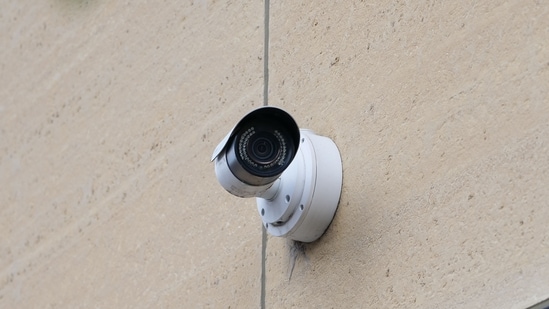 A security camera mounted on a wall, representing the devices being reviewed by major e-commerce platforms in India for regulatory compliance.