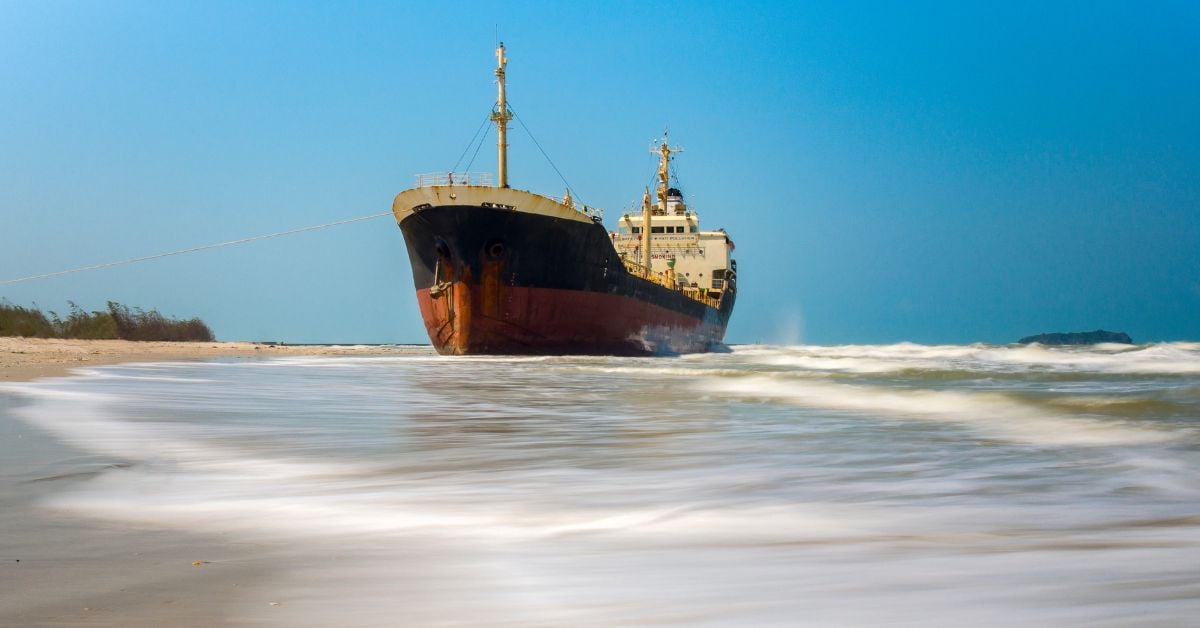 A stranded bulk carrier aground in coastal waters, similar to the grounded ship where four bodies were recovered in Mumbai.