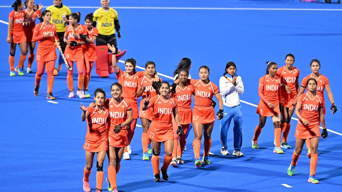 India women’s hockey players celebrate after clinching Asian Games gold with a win over China.